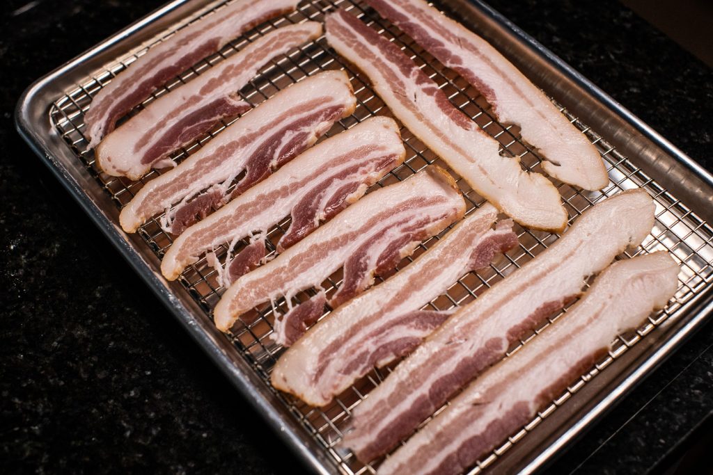 raw bacon on oven tray