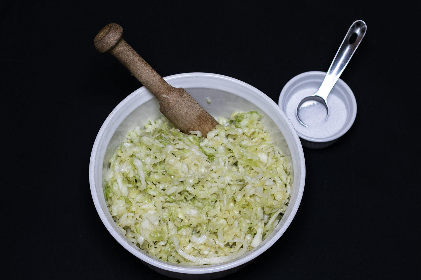 Bowl of shredded cabbage and mallet