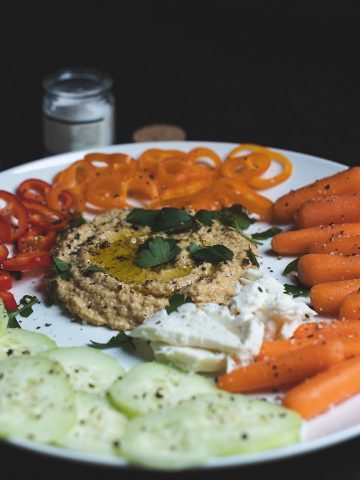 raw veggetable plate hummus carrot pepper mozzarella cucumber parsely