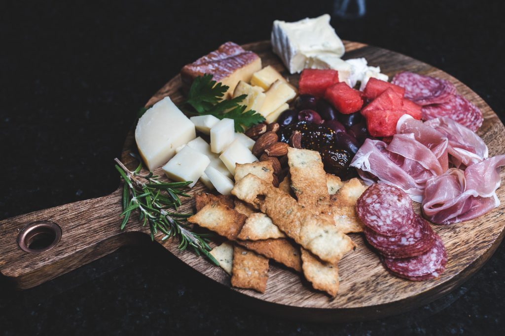 cheese and meat plate with rosemary crackers and fig
