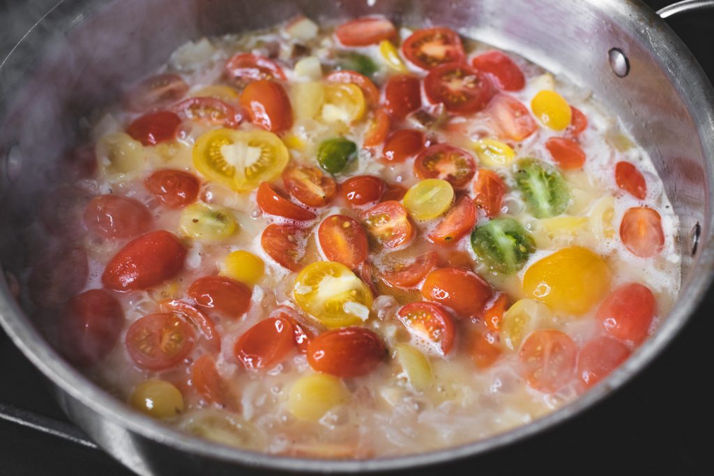 tomatoes cooking down into butter wine sauce