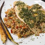 finished and plated tilapia and carrot top pesto with israeli couscous and carrots