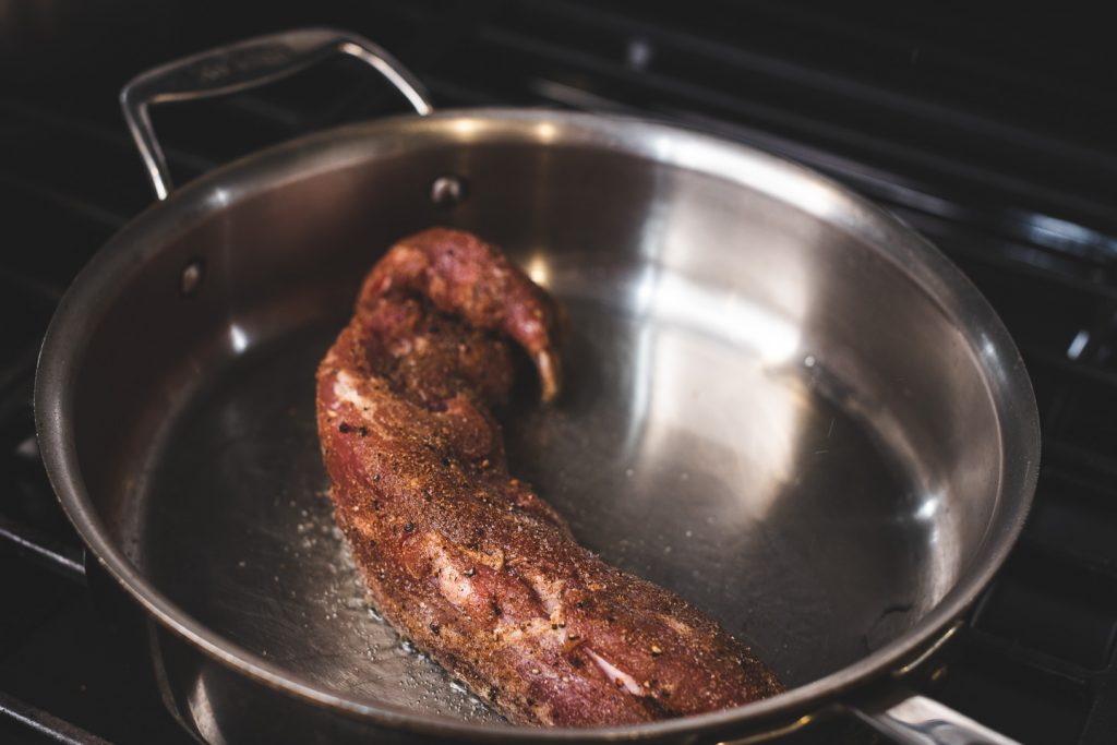 pork tenderloin placed in all-clad pan to sear