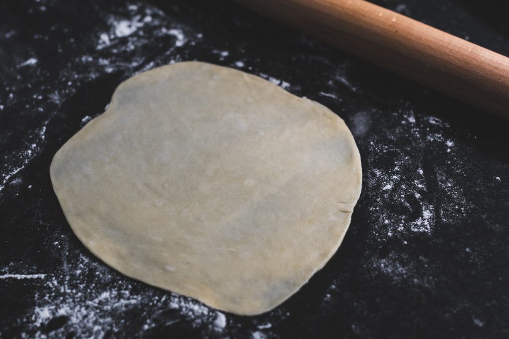 rolling out tortillas as thin as possible