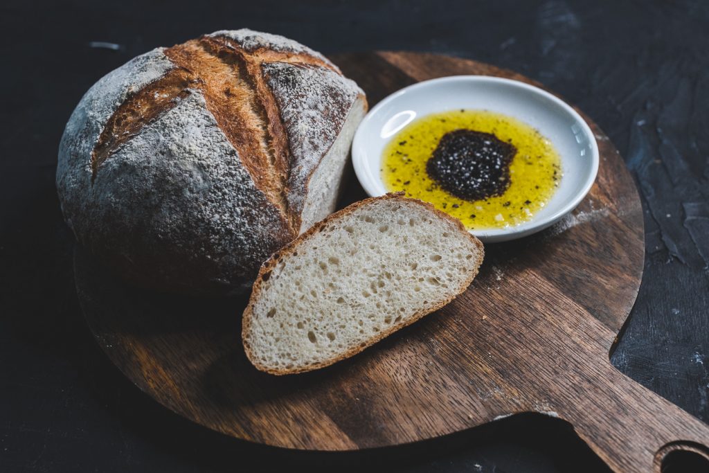 cut bread on board with olive oil and balsamic vinegar