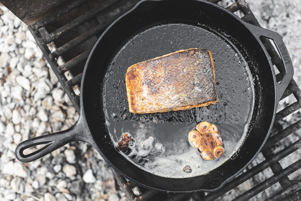 salmon cooking in lodge cast iron pan after skin is crispy [copyright david lewetag ii]